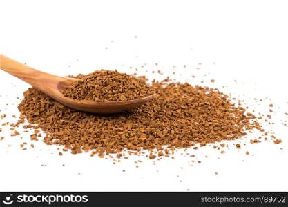 Heap of instant coffee in spoon isolated on white background