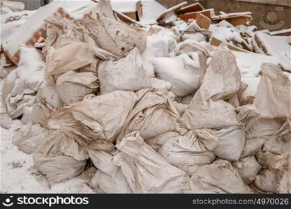 Heap of litter bags covered with snow