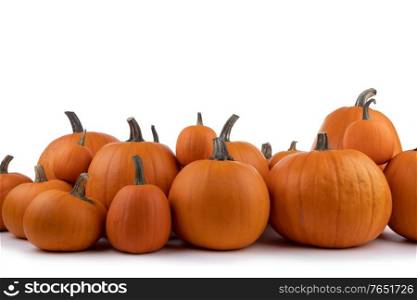 Heap of many orange pumpkins of the same kind isolated on white background , Halloween concept. Many orange pumpkins isolated