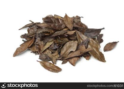Heap of mountain tea leaves of the Meiji, Japanese old style tea, on white background