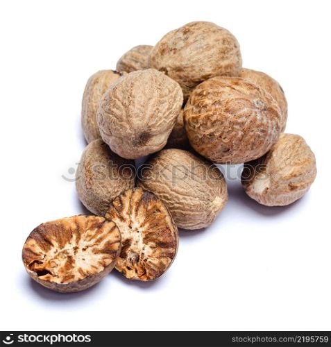 heap of natural organic nutmegs isolated on white background. heap of nutmegs isolated on white background