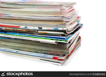 Heap of old magazines isolated on white