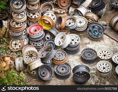 heap of old rusty metal wheel rims in the car dum wheel vehicle waste
