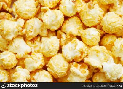 Heap of popcorn with caramel, top view. Popcorn