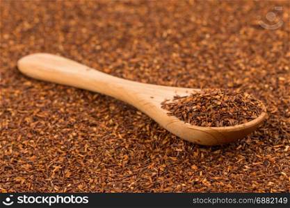Heap of red dry rooibos healthy traditional organic tea in spoon