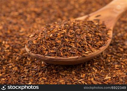 Heap of red dry rooibos healthy traditional organic tea in spoon
