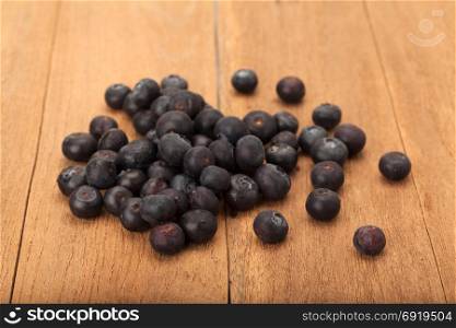heap of ripe blueberry on wood background