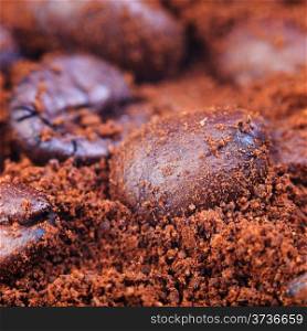 heap of roasted coffee beans in ground coffee close up