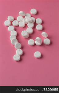 Heap of round white pills. Heap of round white pills on pink background