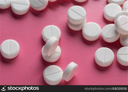 Heap of round white pills. Heap of round white pills on pink background