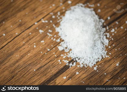 Heap of salt on wood background