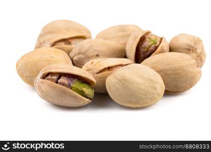 Heap of salted pistachio nuts isolated on white background