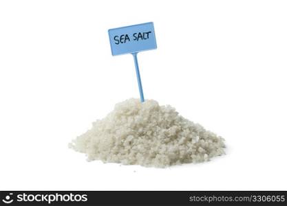 Heap of sea salt with a sign on white background