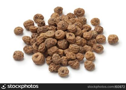 Heap of shelled Chufa nuts on white background