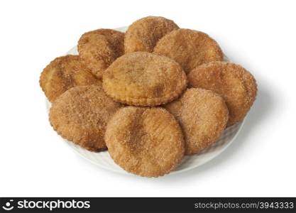 Heap of sugared fried apple fritters or appelflappen on a dish on white background