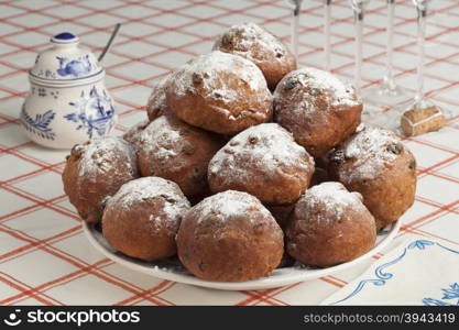 Heap of sugared fried fritters or oliebollen on a dish
