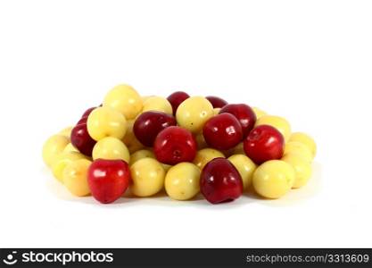 Heap of sweet red and yellow cherries isolated on white