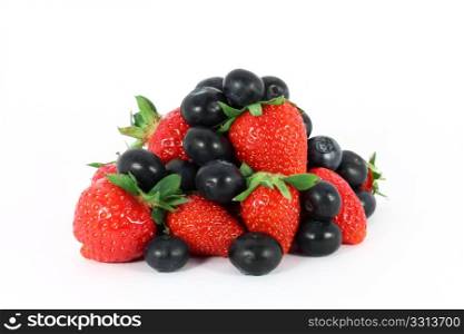 Heap of sweet strawberries and blueberries isolated on white