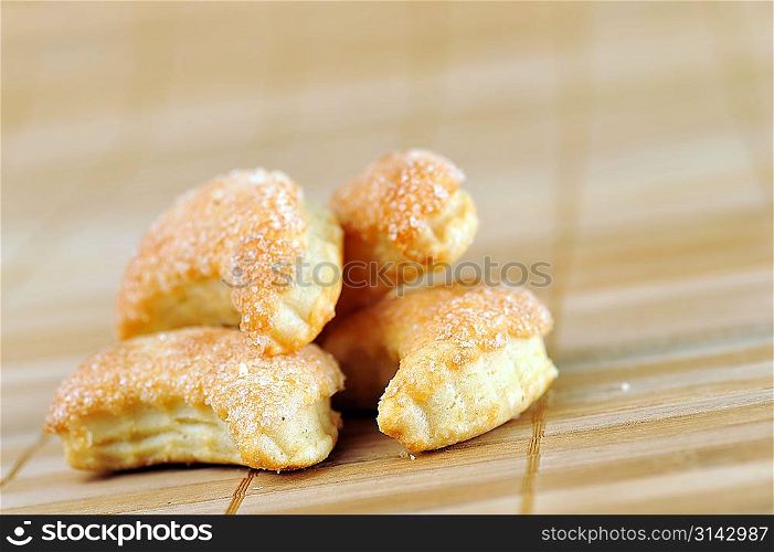 heap of tasty cookies on bamboo napkin close up