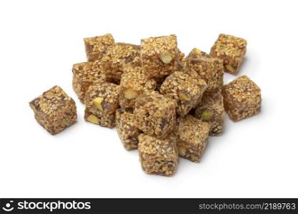 Heap of Turkish delight., lokum, with sesame seed and pistachio nuts close up isolated on white background