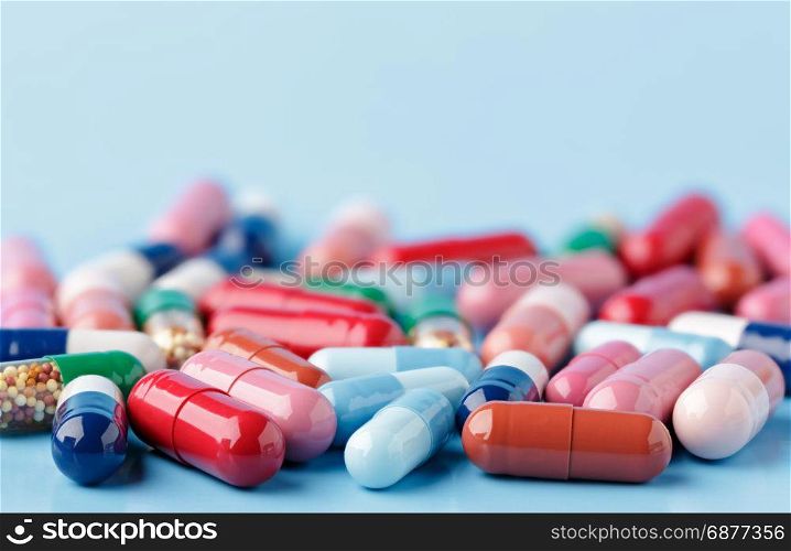 Heap of various pills on color background. Heap of various pills on blue background