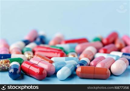 Heap of various pills on color background. Heap of various pills on blue background