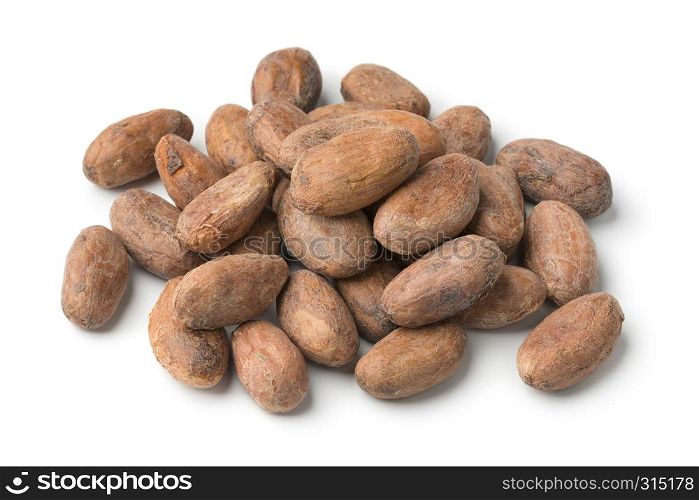 Heap of whole cocoa beans close up isolated on white background