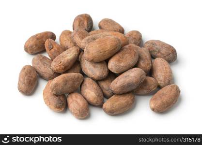 Heap of whole cocoa beans close up isolated on white background