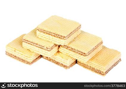 Heap of yellow sweet chocolate waffles. Isolated on white background. Close-up. Studio photography.
