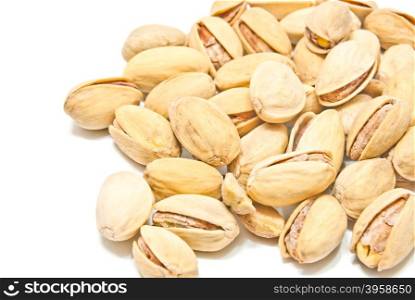 heap of yummy roasted pistachios on white background