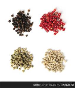 Heaps of assorted peppercorns on white background, top view