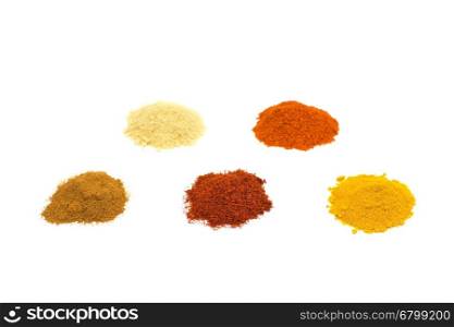 Heaps of five seasoning spices isolated on white background