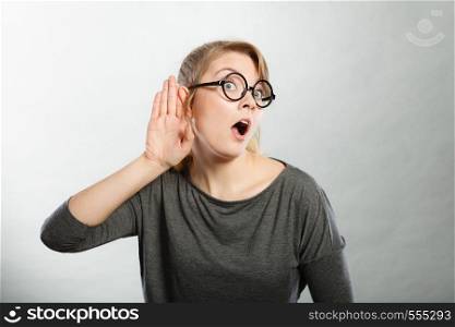 Hearing gesture shock emotion concept. Shocked girl eavesdropping. Young nerdy stunned lady in glasses listening expressing disbelief gasping.. Shocked girl eavesdropping.