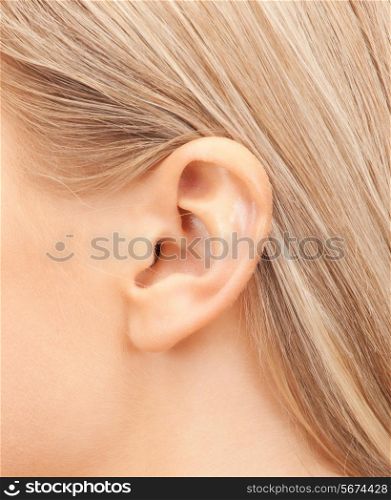 hearing, health, beauty and piercing concept - close up of woman&#39;s ear