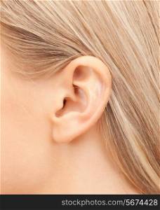 hearing, health, beauty and piercing concept - close up of woman&#39;s ear