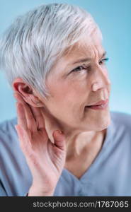 Hearing Loss. Senior Woman with Symptoms of Hearing Loss.