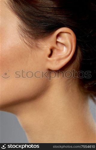 hearing, people and beauty concept - close up of young woman ear. close up of young woman ear