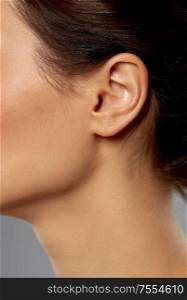 hearing, people and beauty concept - close up of young woman ear. close up of young woman ear