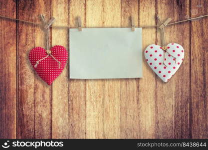 Heart and paper hanging on wood Background and Texture, Vintage toned.