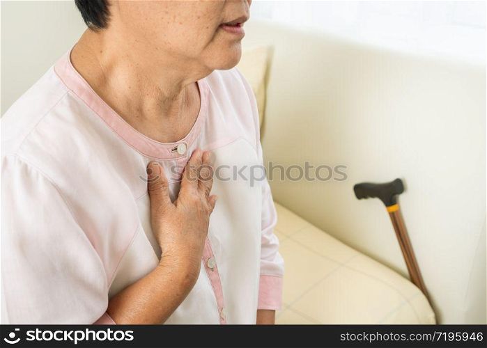 heart attack old woman holding chest in bed room, healthcare problem of senior concept
