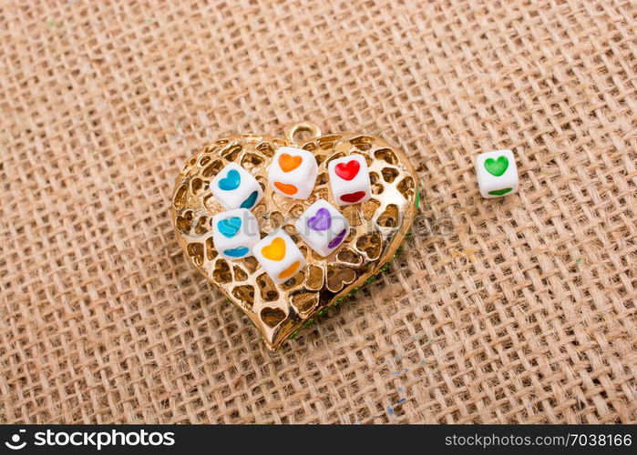 Heart cubes on Heart shaped gold color object