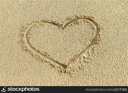 Heart drawing in the sand on the beach