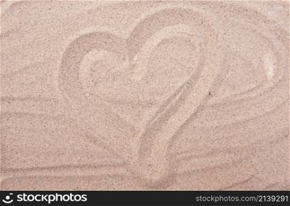 heart drawing on sea sand background or texture. heart drawing on sea sand