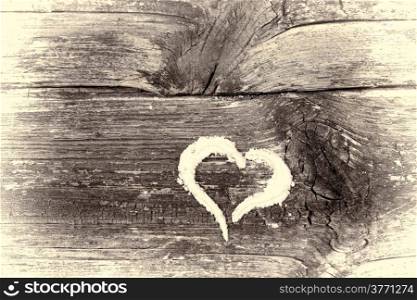 Heart drawn in flour on an antique table