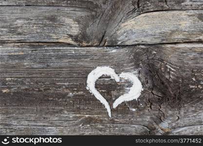 Heart drawn in flour on an antique table