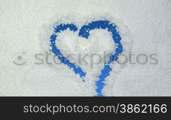 Heart drawn on snow background with matte