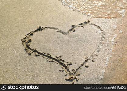 Heart drawn on the beach sand. Heart drawn on the beach sand. heart symbol on the sand washed by the sea wave.