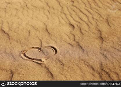 Heart drawn on the sand, concept of love. Relax on the sandy beach. Copy space. Valentine&rsquo;s day on a sunny beach. Heart drawn on the sand, concept of love. Relax on the sandy beach. Copy space. Valentine&rsquo;s day on a sunny beach.