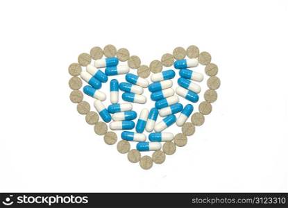Heart from pills on a white background