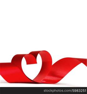 Heart from red ribbon isolated on white background